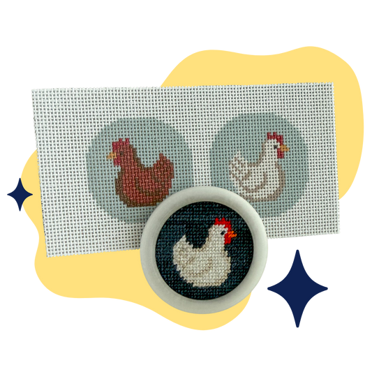A circular needlepoint canvas featuring a stitched white hen with a red comb on a dark background, shown in front of a larger rectangular canvas with two hen designs. The items are styled on a white background with yellow abstract shapes and blue star accents.